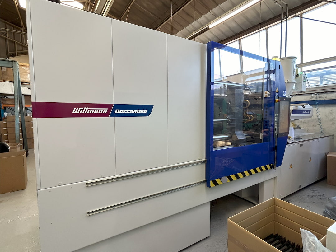 An injection moulding machine in a factory.